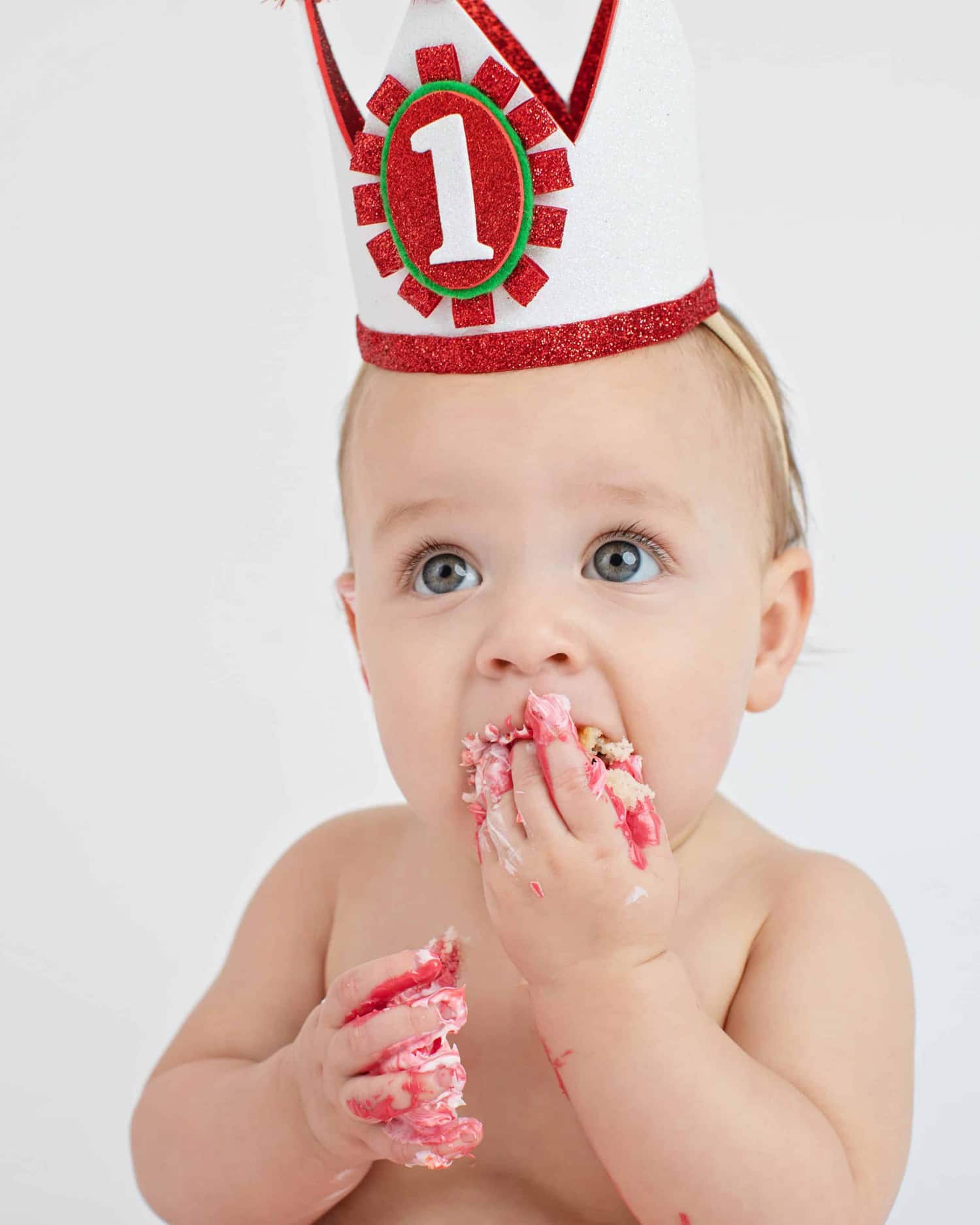 A baby in a birthday hat.