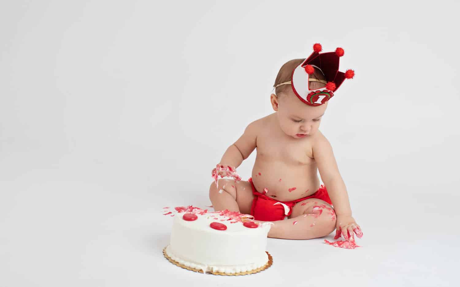 A six-month-old with a birthday cake.