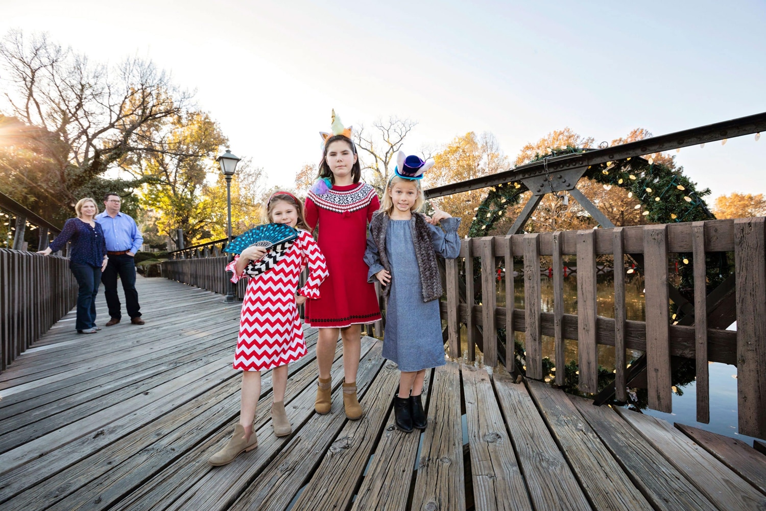 A group of siblings takes a photo on a bridge.