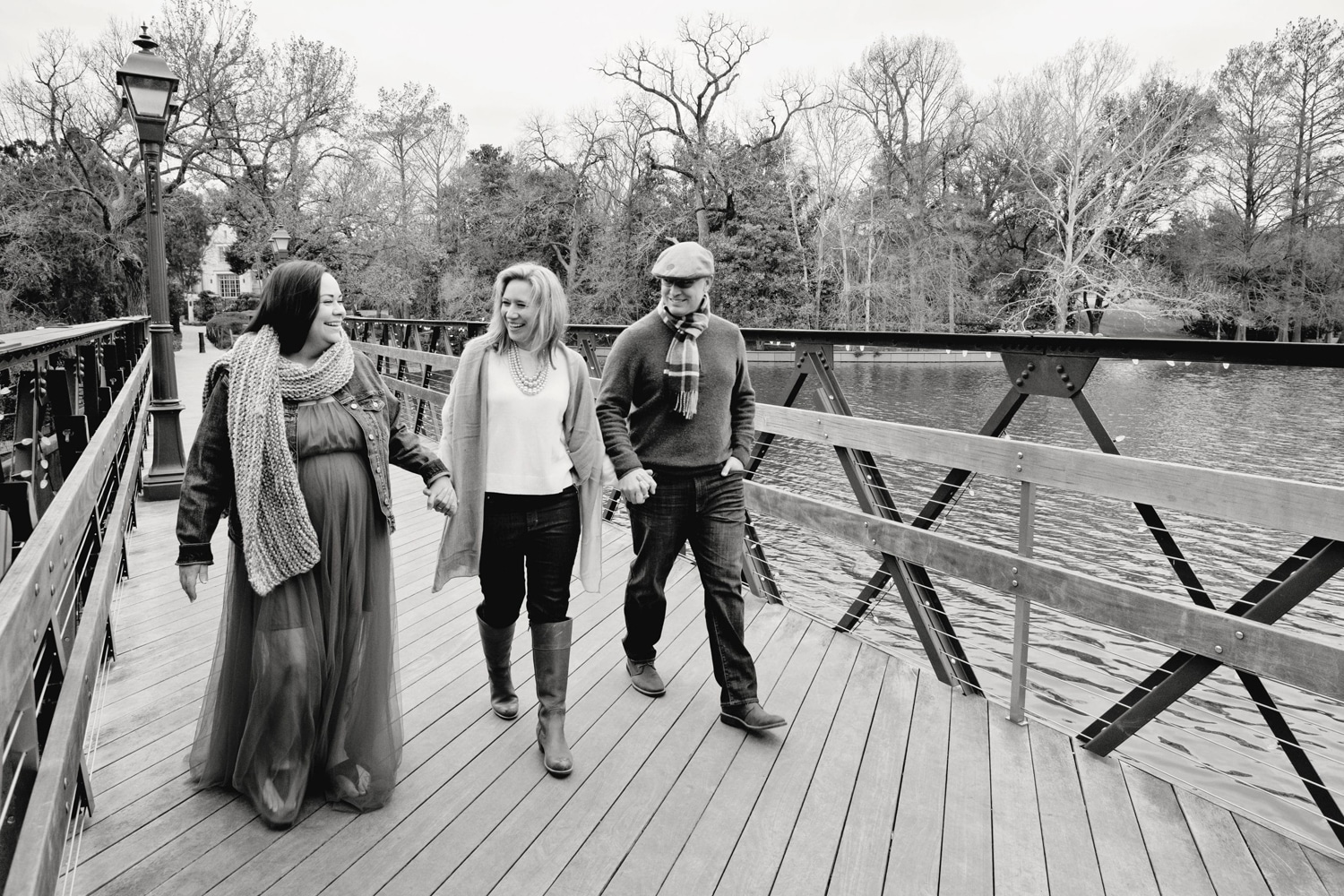 Black and white photo of a surrogate mother with the two parents.