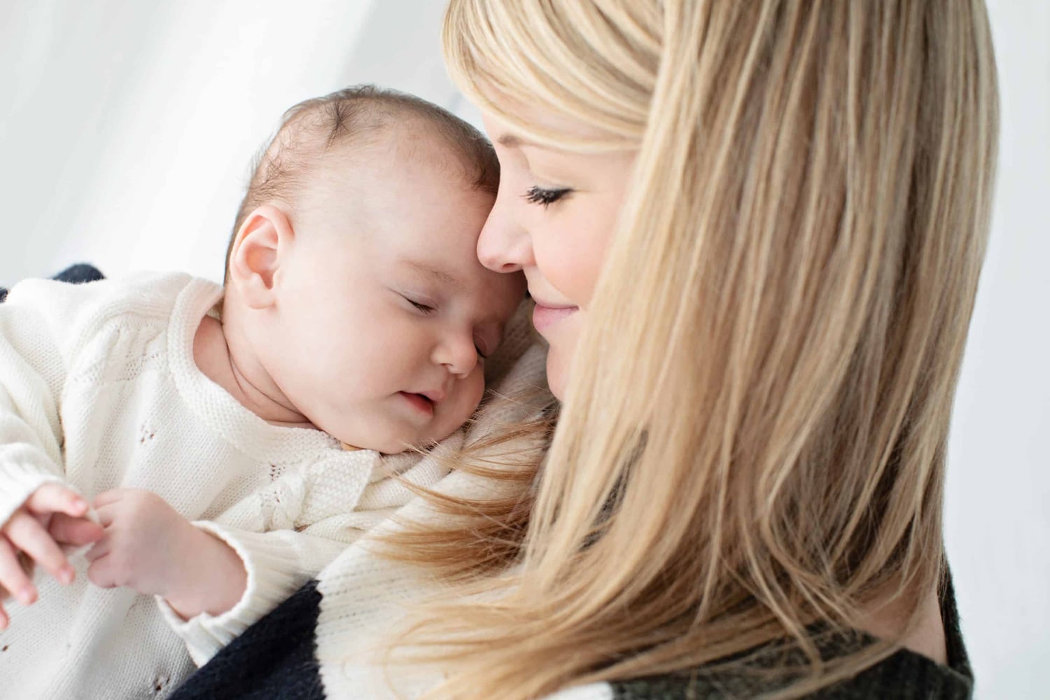 A woman holds her newborn baby.