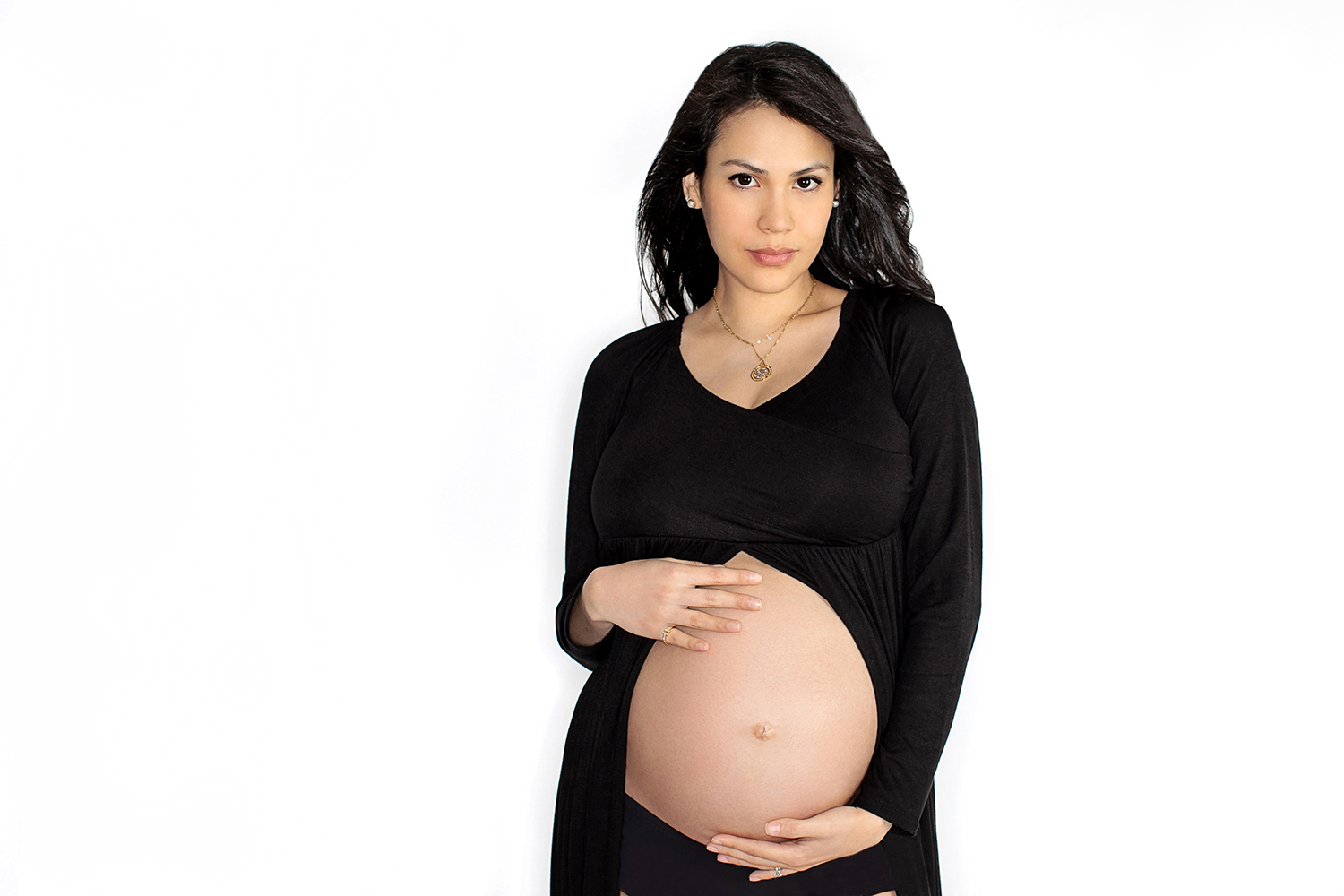 maternity image of woman with hands on belly