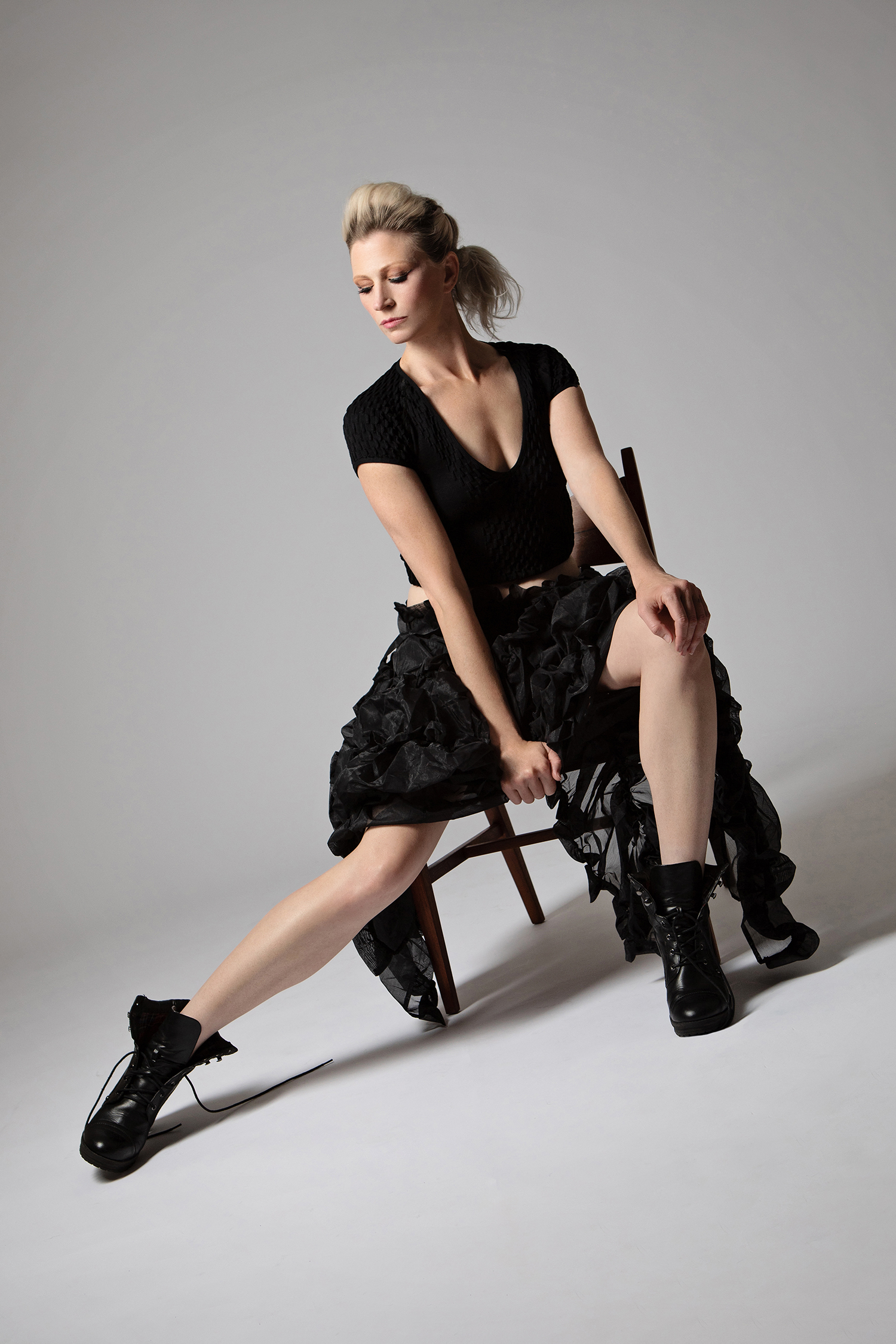woman in black skirt and boots for fashion portrait