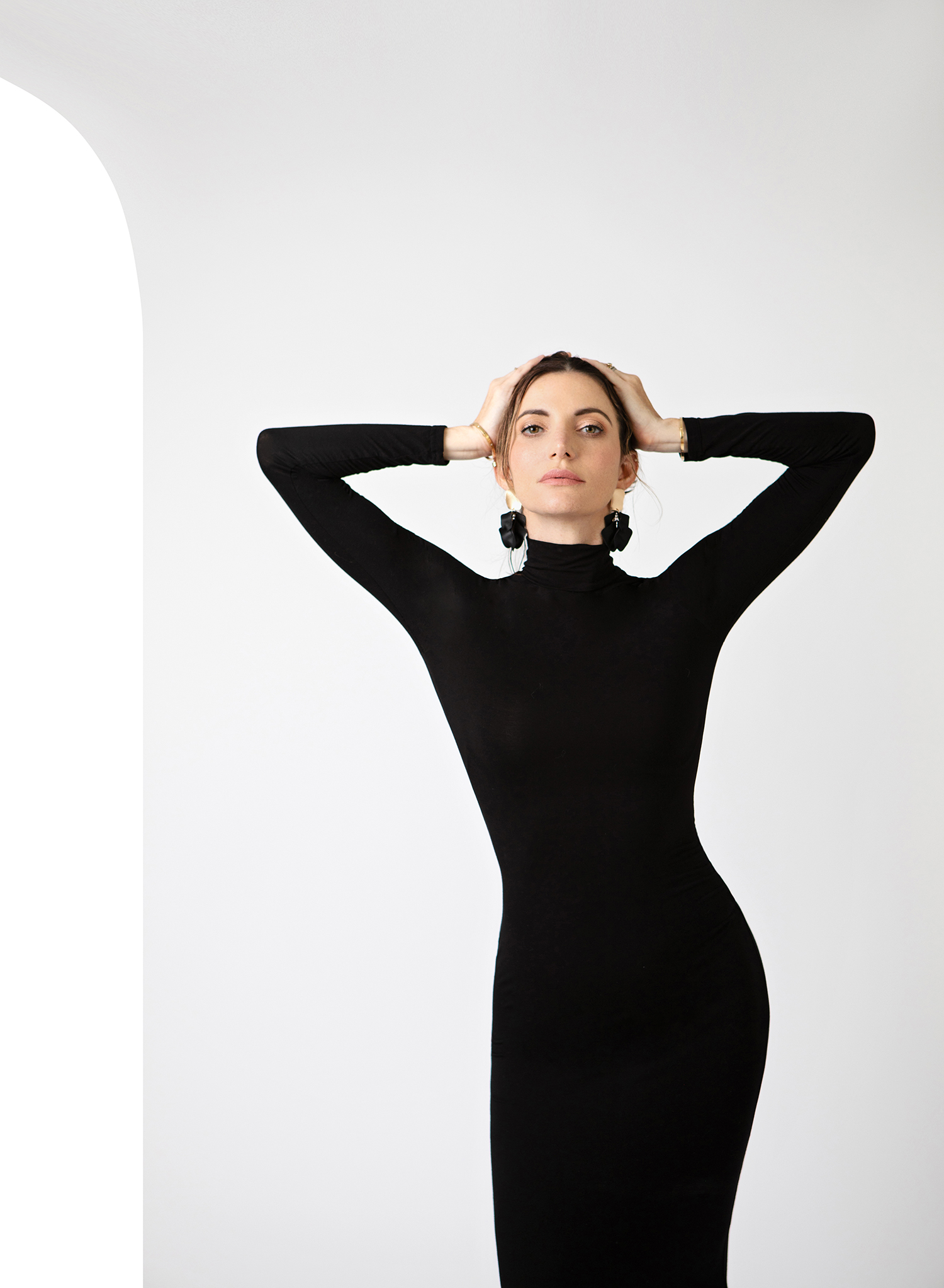 dramatic pose for fashion image with woman in black dress
