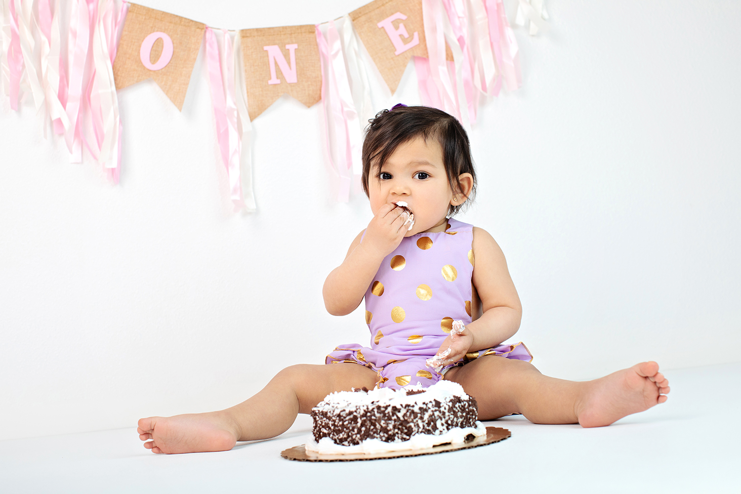 Adorable Baby Celebrating First Birthday with Cake Smash