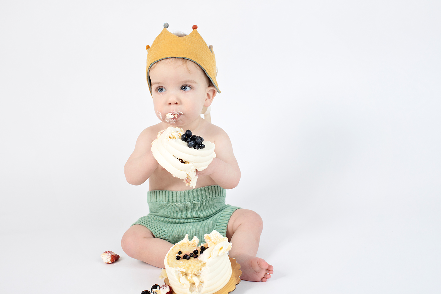 an adorable baby's hands are covered in cake frosting