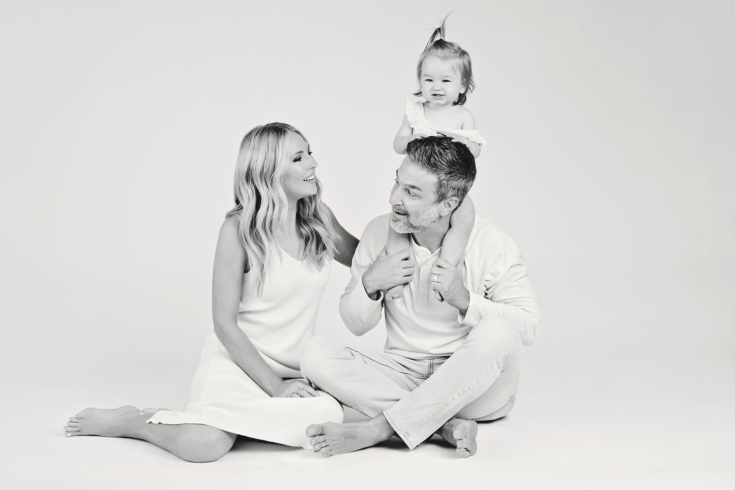 a black and white family photo at a one year baby photoshoot