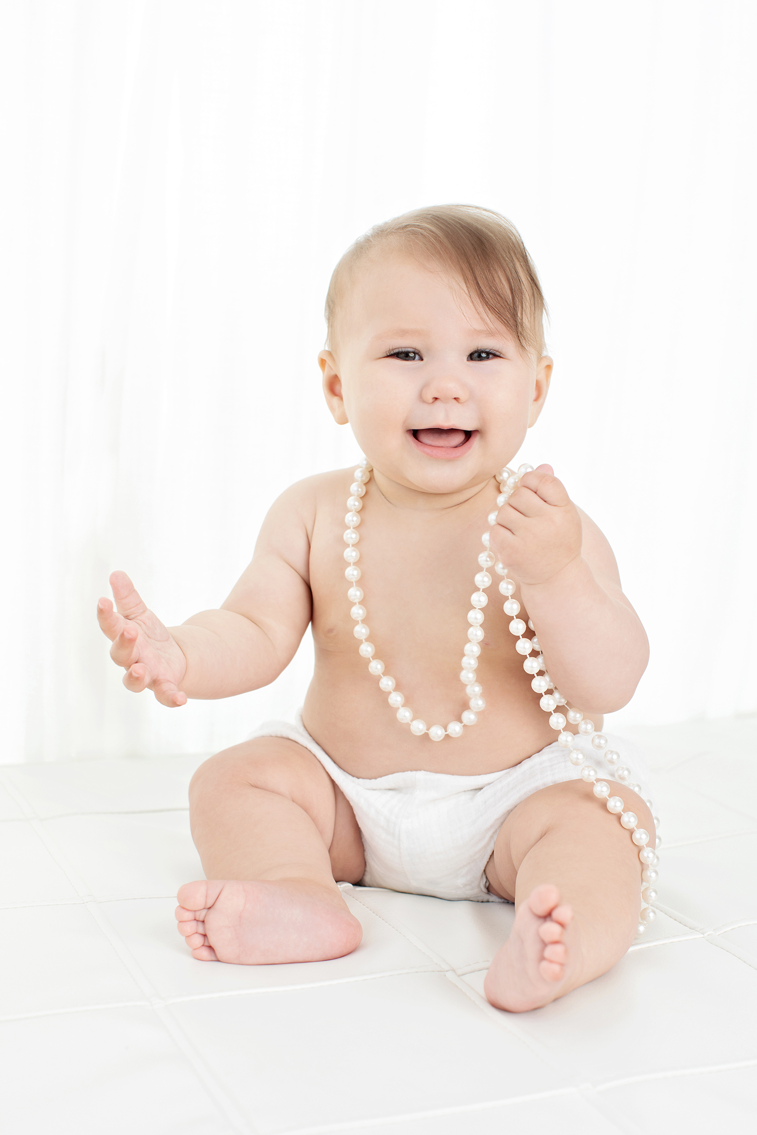 a baby dressed in pearls