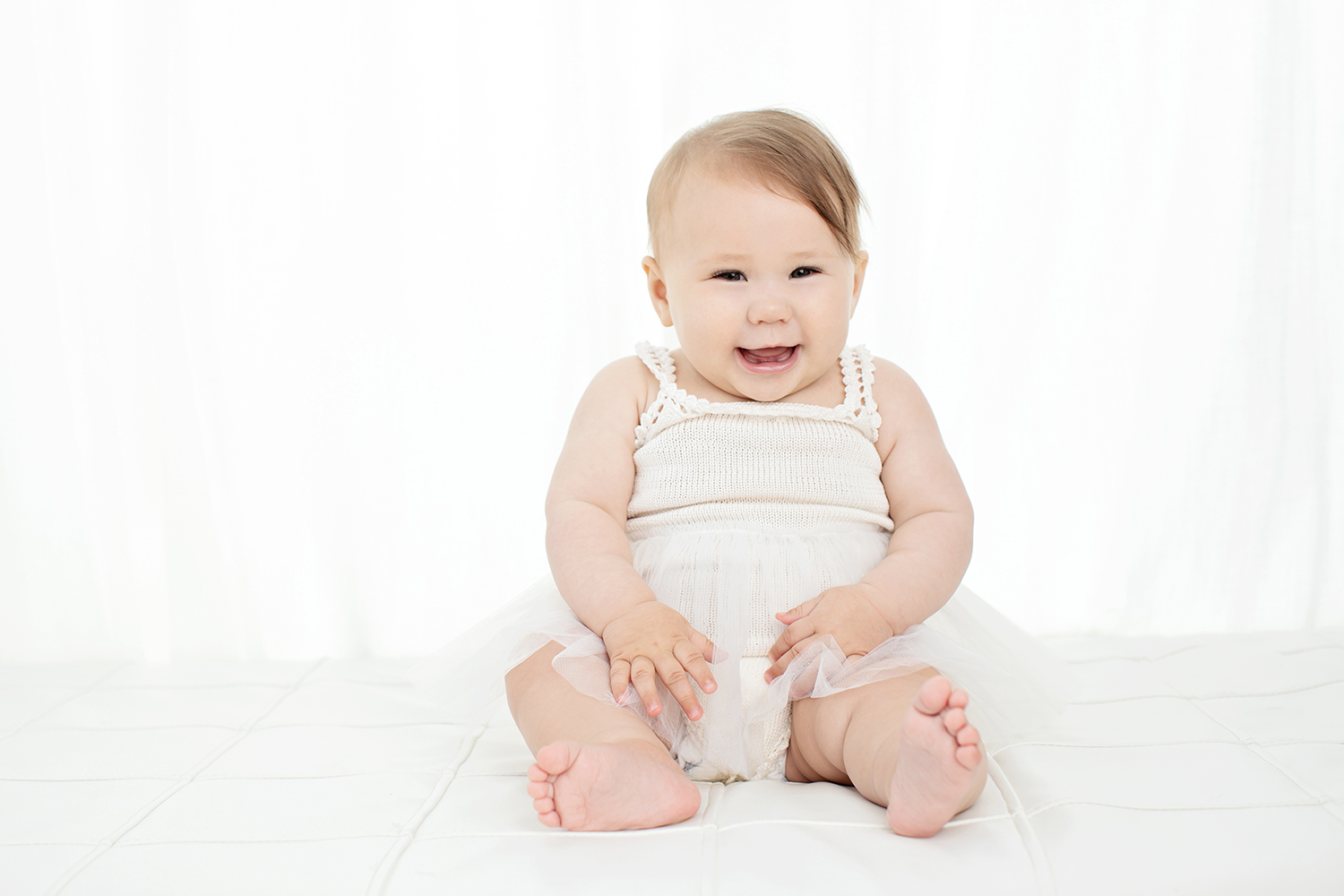 baby girl with bright eyes and a big smile