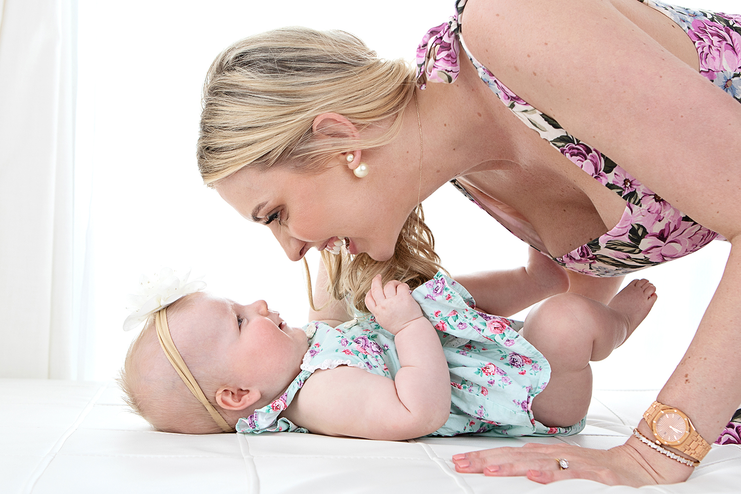 photo of a mother kissing her baby girl