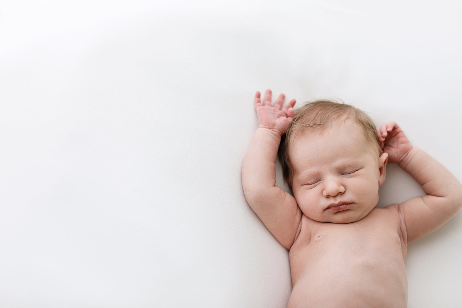 A close-up of a peaceful newborn sleeping soundly