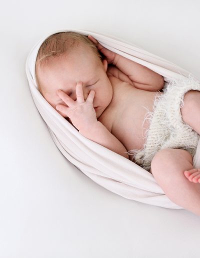 A close-up of a peaceful newborn sleeping soundly