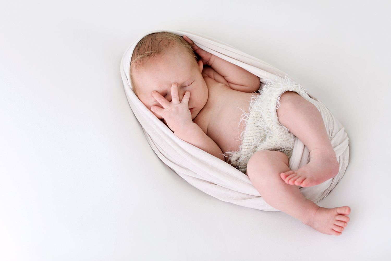 A close-up of a peaceful newborn sleeping soundly