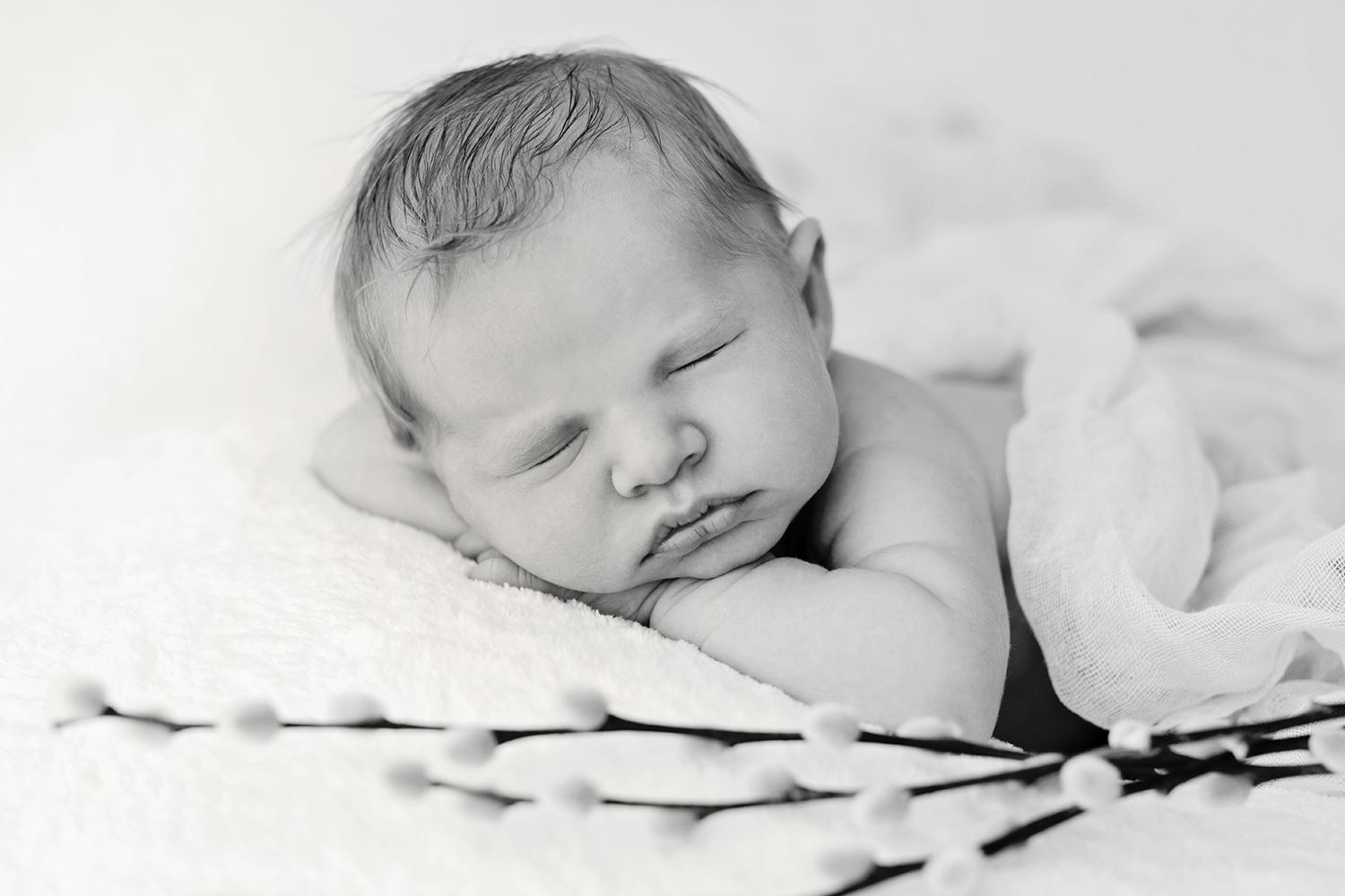 a sleeping baby in black and white at a newborn photoshoot