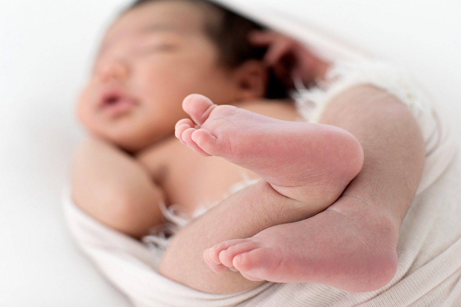 tiny toes of a newborn in soft focus