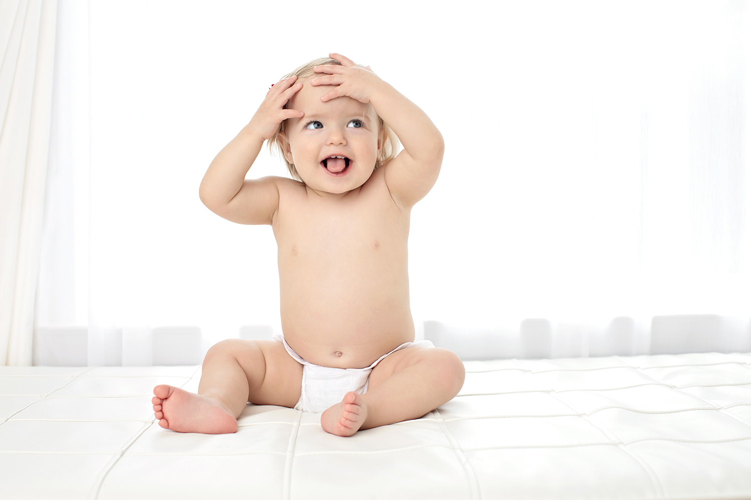 one year old playfully covers head at milestone shoot