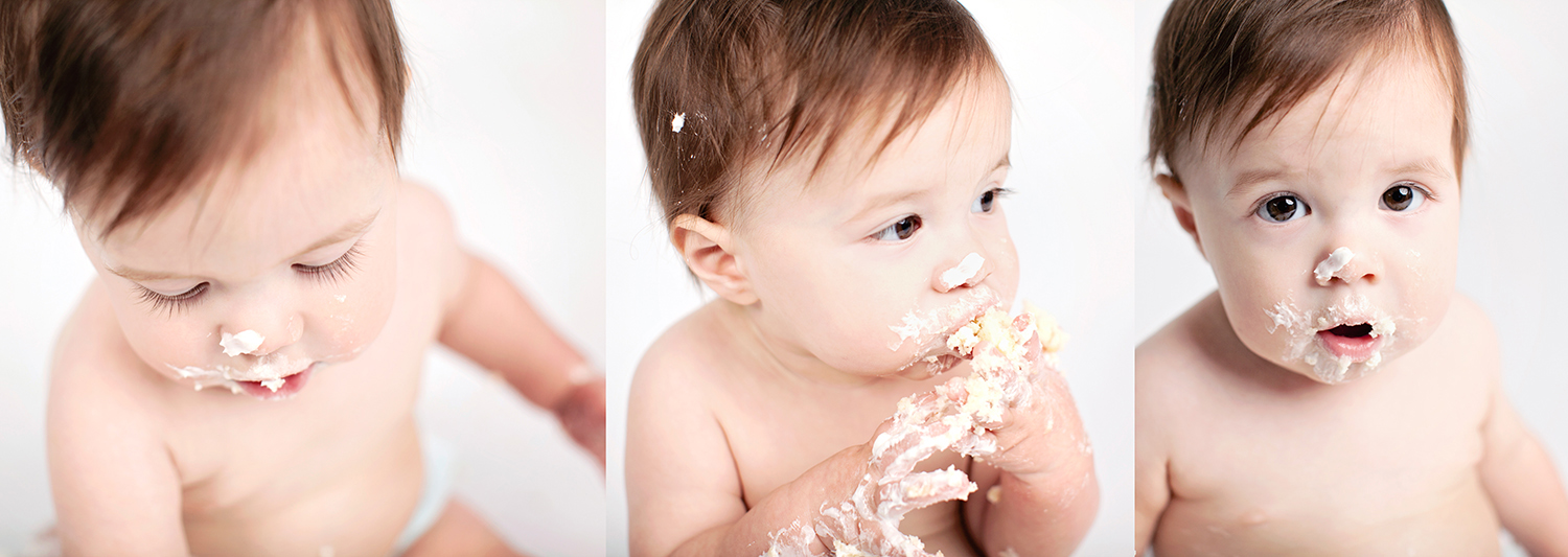one year old baby stuffs birthday cake in her mouth at cake smash