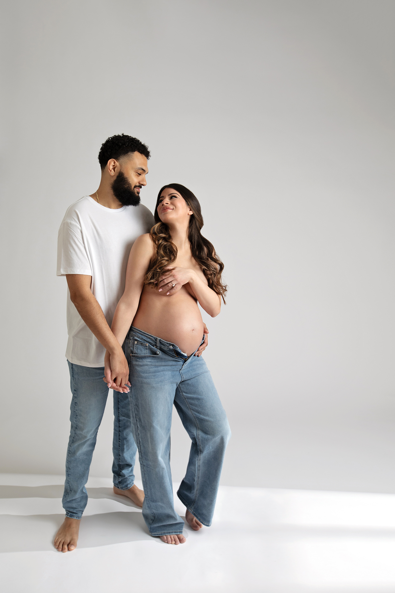 A couple embraces during a maternity photoshoot