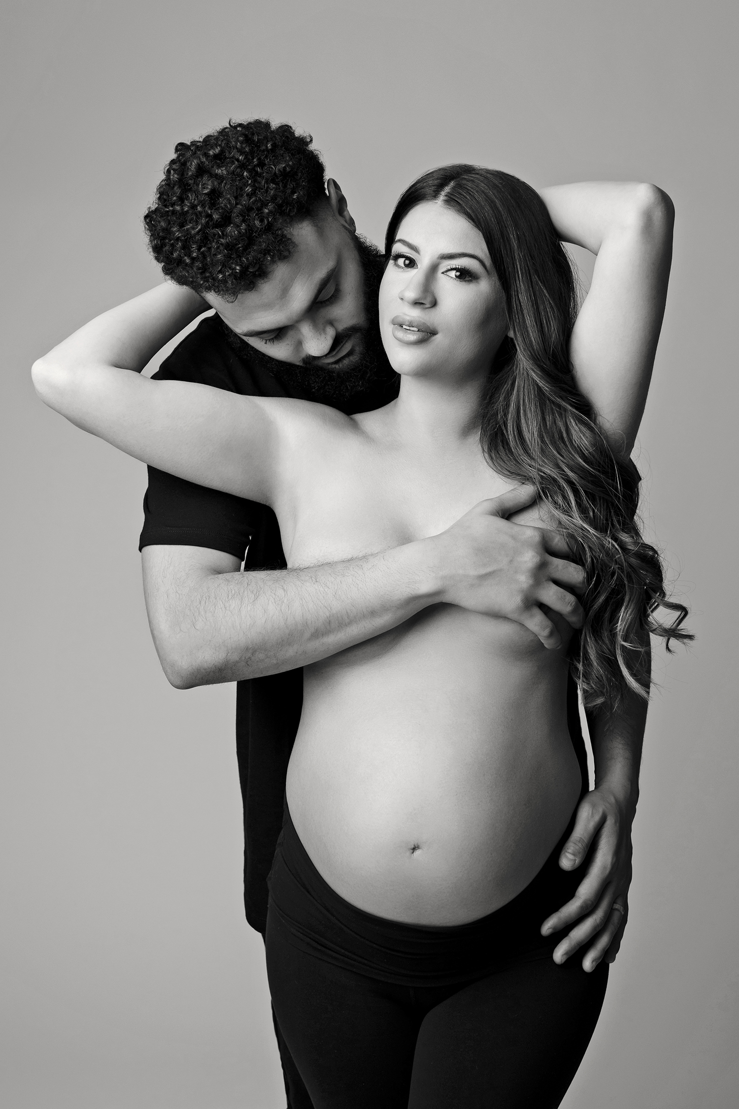 A couple embraces during a maternity photoshoot