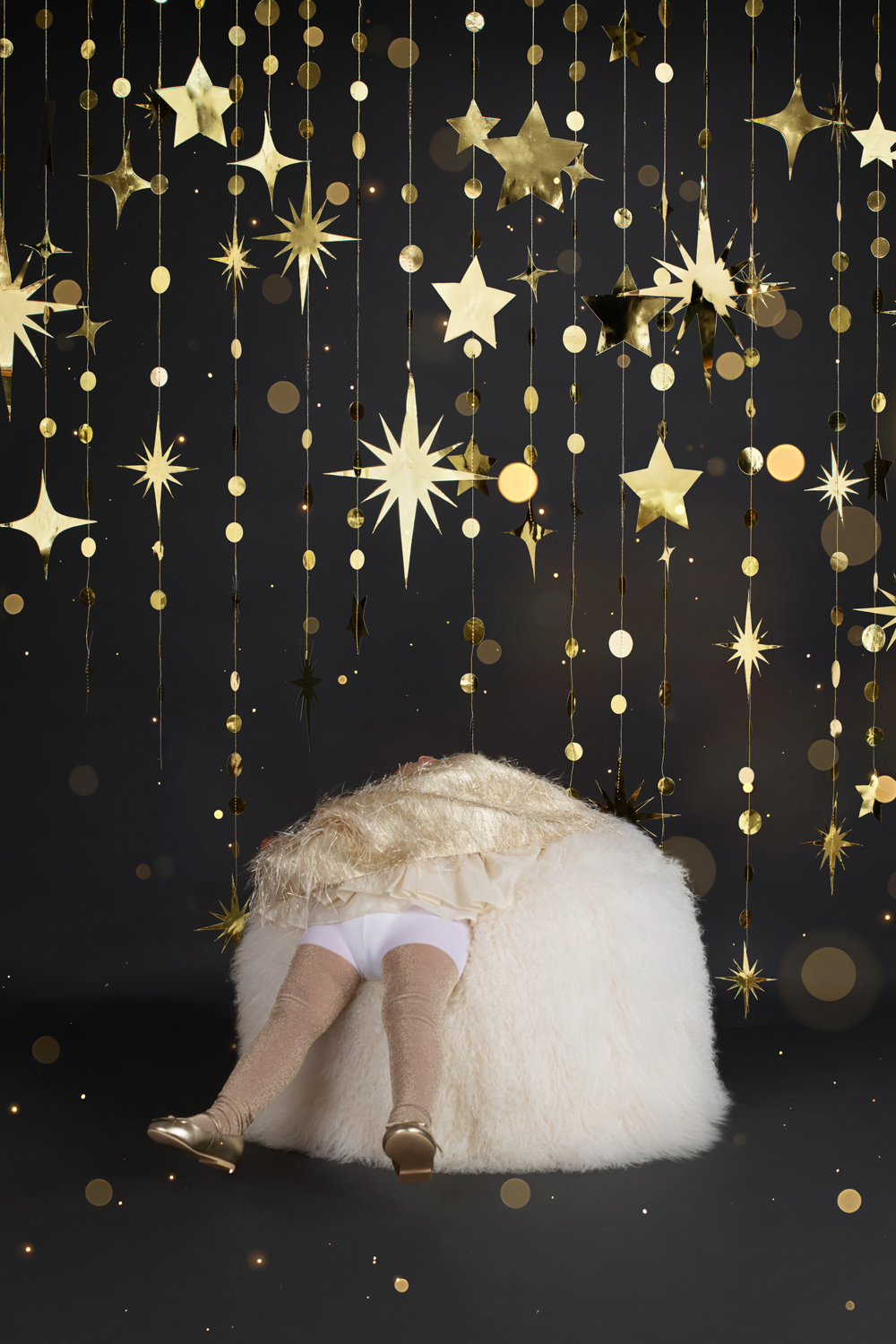 a little girl posing in a gold dress during a Dallas family photoshoot