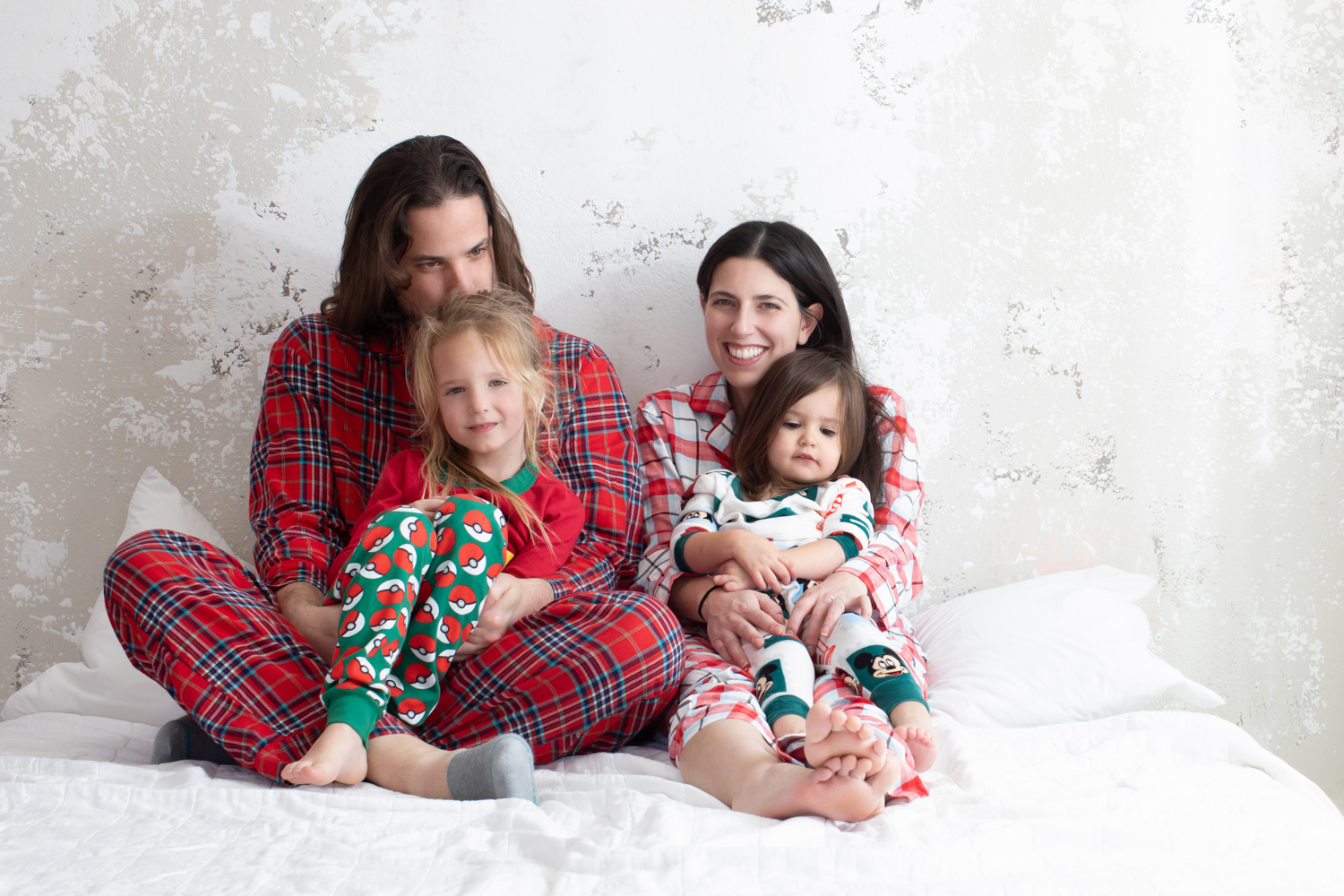 Family wearing holiday pajamas during a cozy Dallas Christmas photoshoot