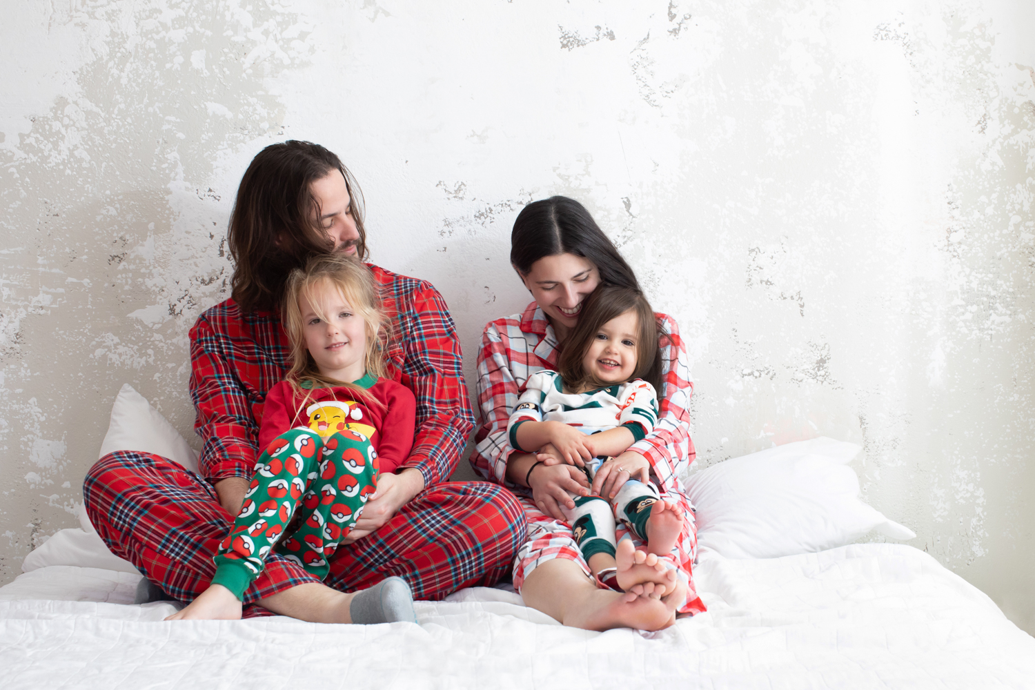 Family wearing holiday pajamas during a cozy Dallas Christmas photoshoot