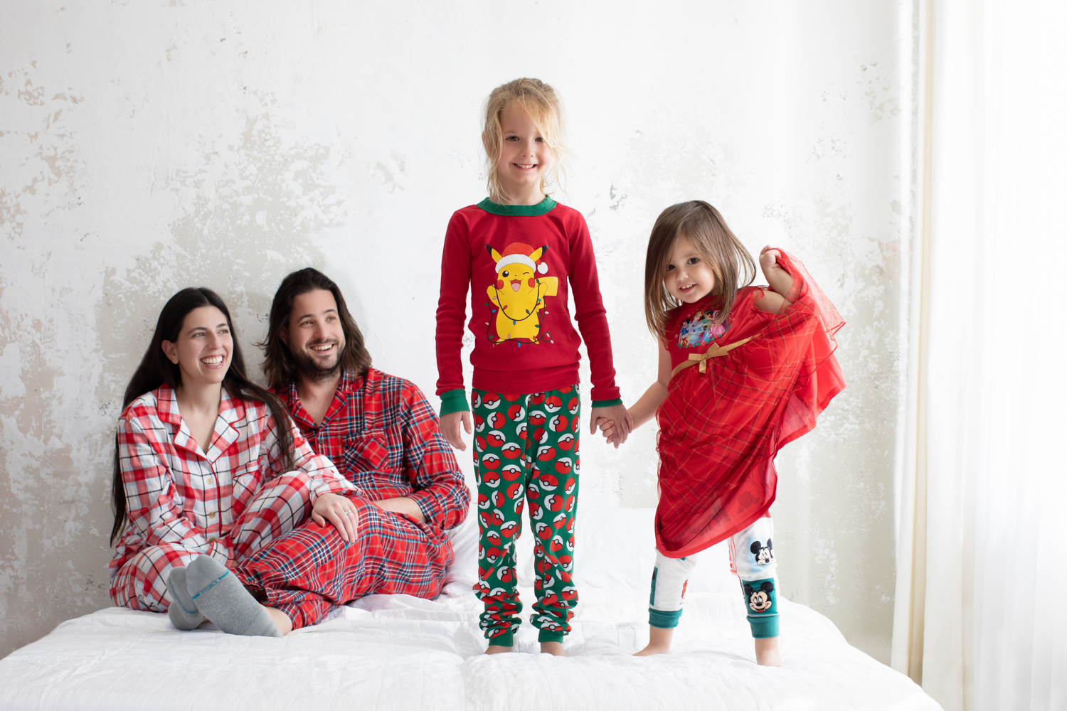 Family wearing holiday pajamas during a cozy Dallas Christmas photoshoot