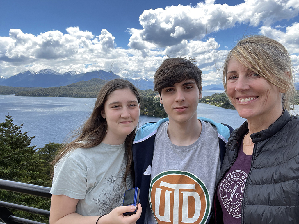Photo of family in front of a blue sky and lake in Argentina