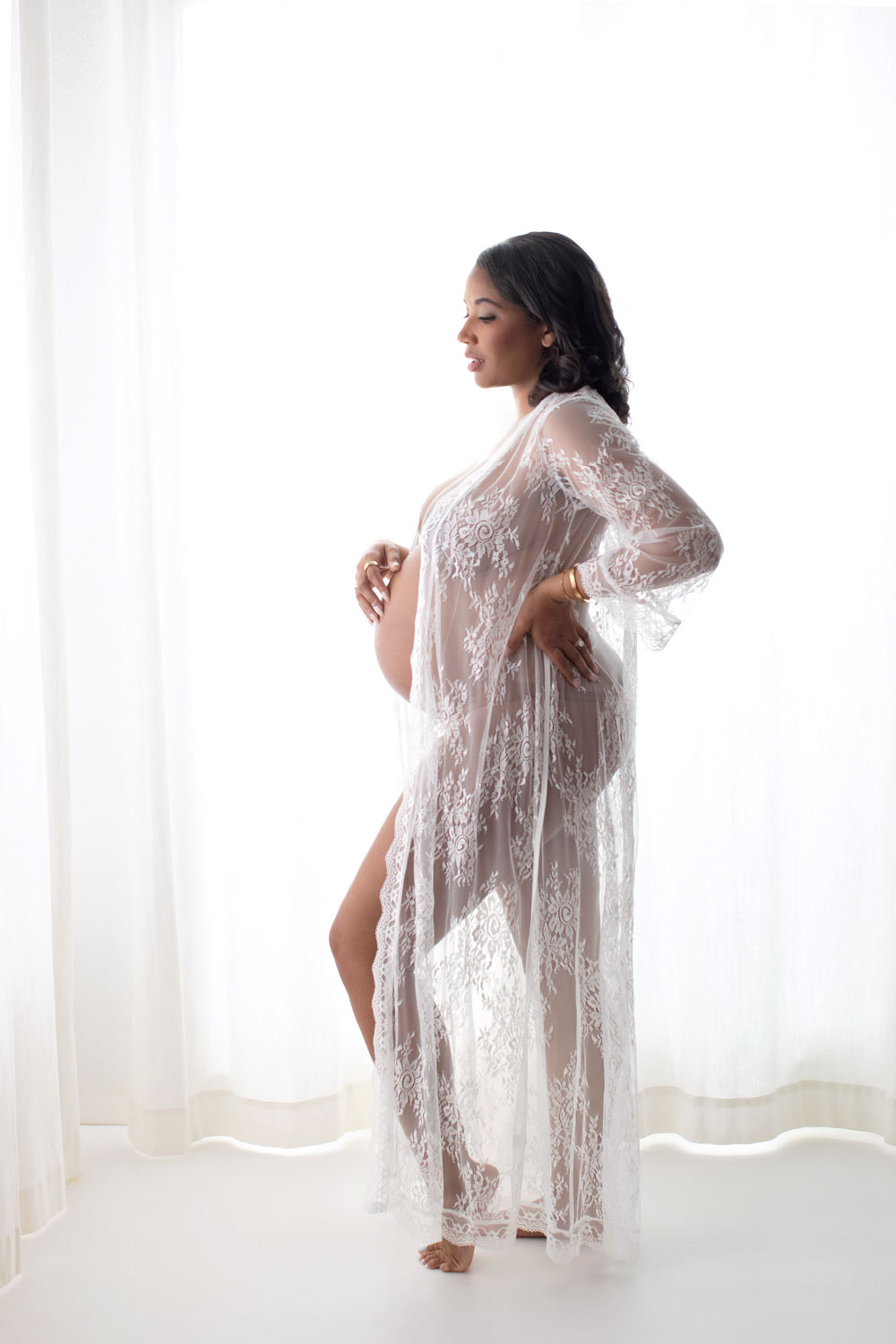 Pregnant woman in flowing gown at outdoor Dallas maternity session