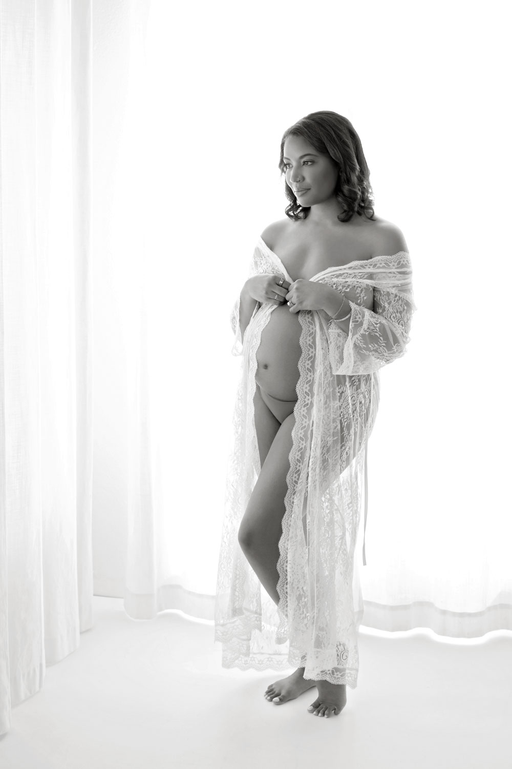 Pregnant woman in flowing gown at outdoor Dallas maternity session
