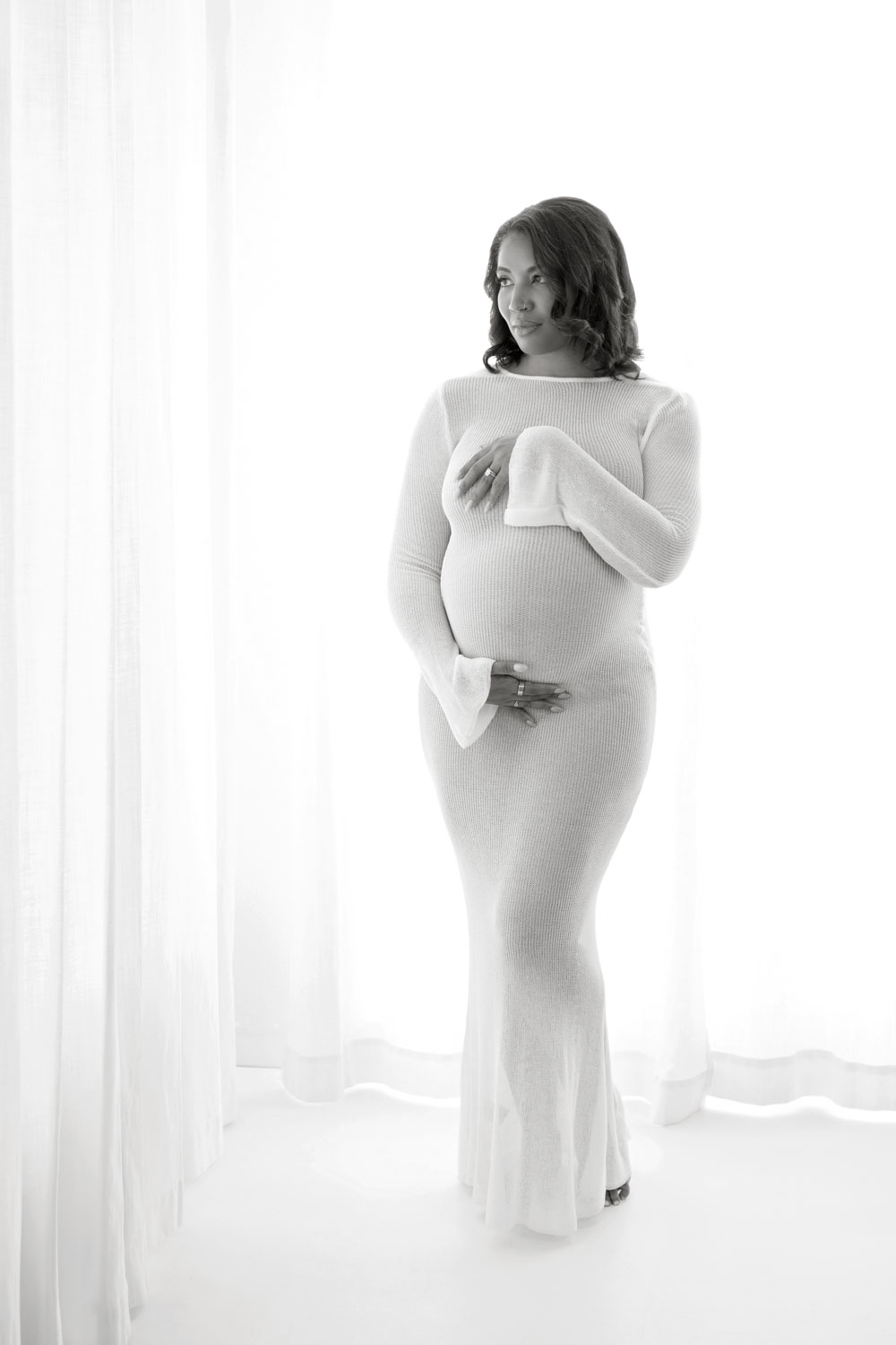Pregnant woman standing in soft natural light, Dallas maternity photos