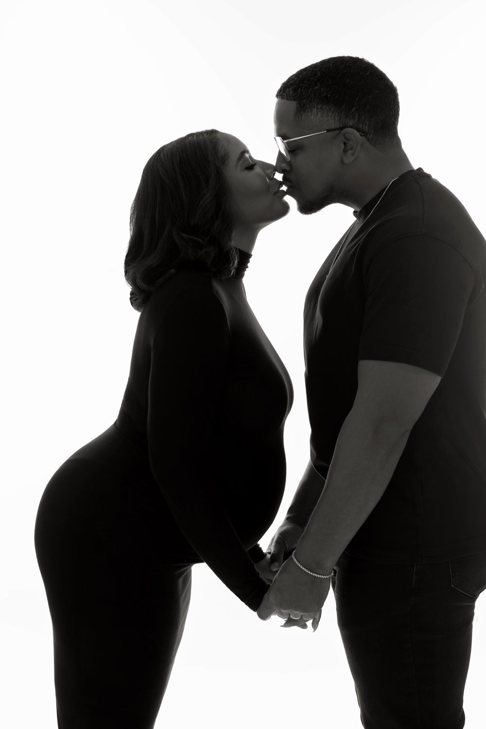 Pregnant couple embracing during Dallas maternity session