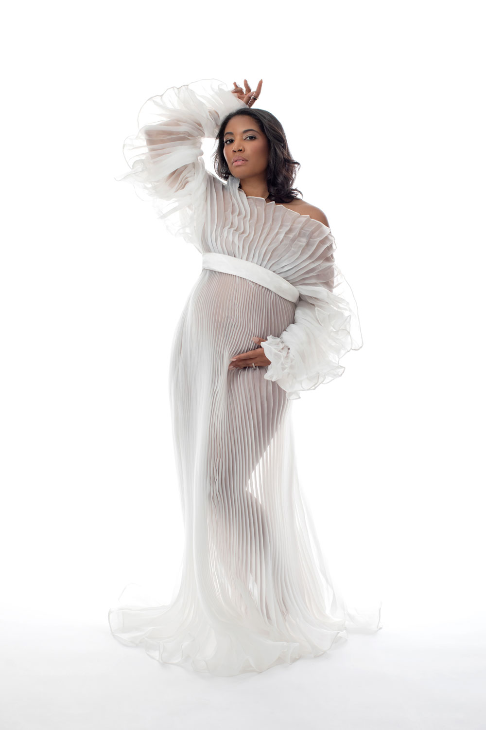 Maternity portrait with draped fabric, soft studio light Dallas
