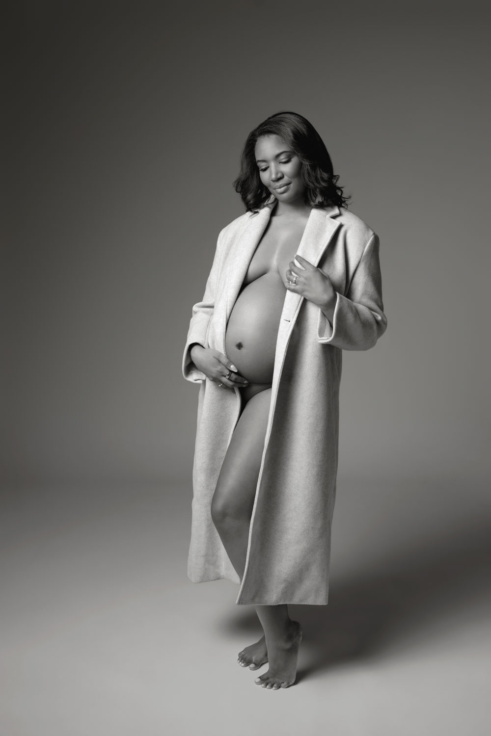 Pregnant woman standing in soft natural light, Dallas maternity photos